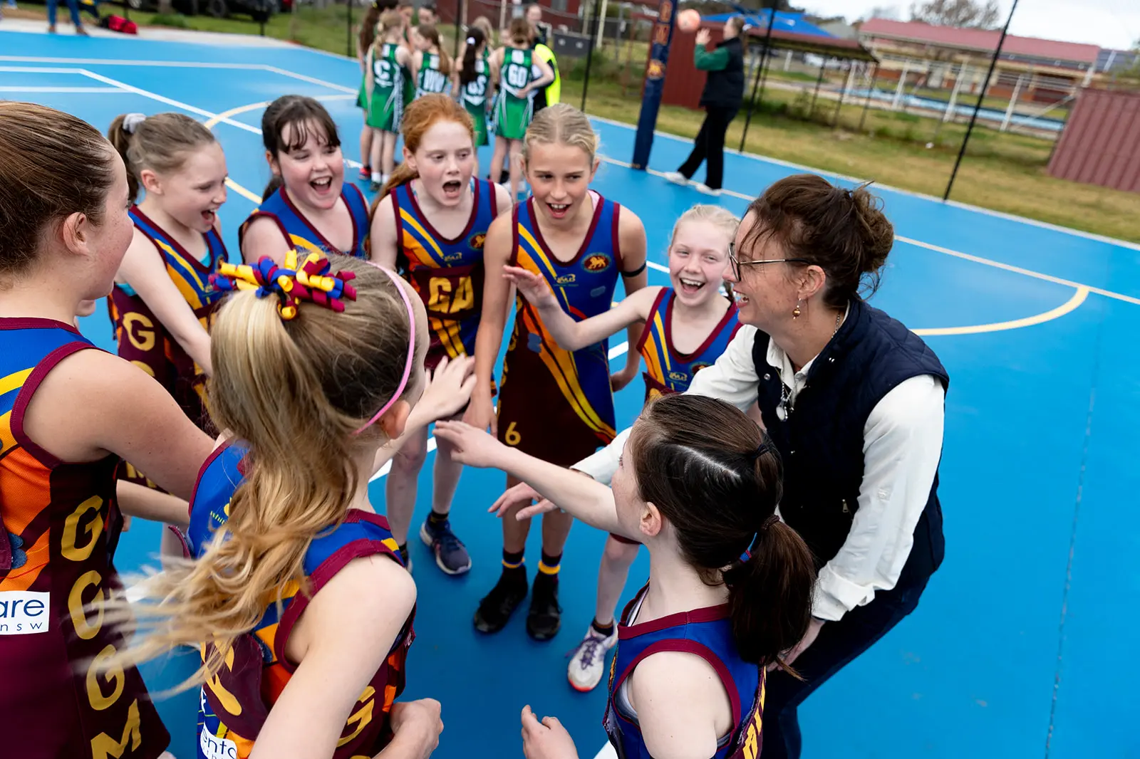 <p>Steph Cooke with young netballers at the Ganmain GGM Football Club</p>\\n