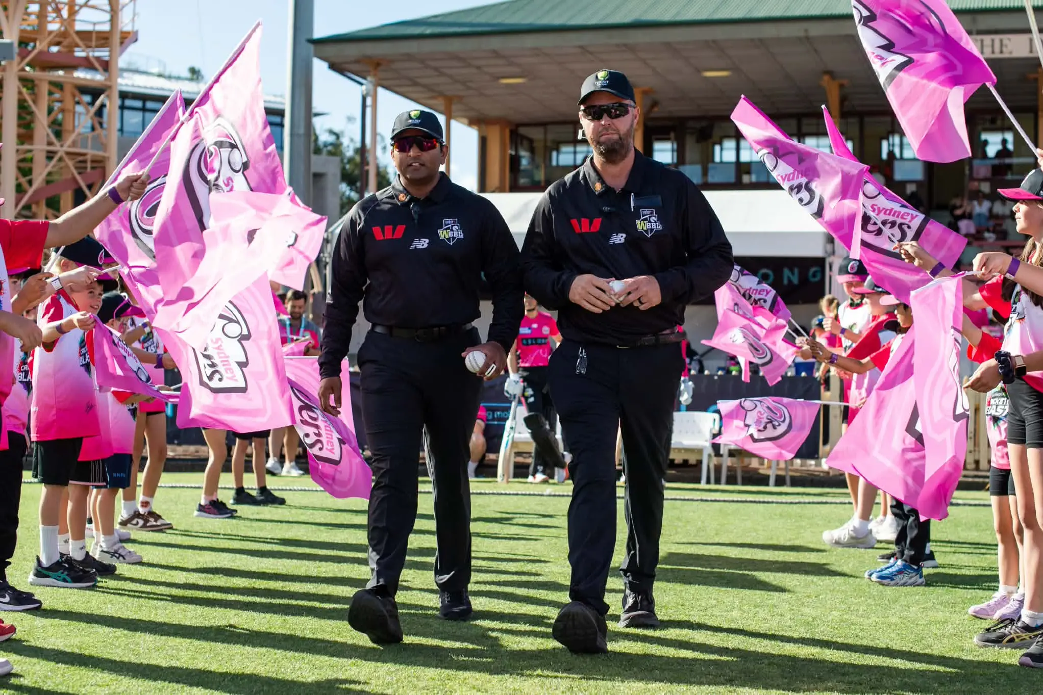 <p>Egan and fellow umpire Sharad Patel stride onto North Sydney Oval for a WBBL fixture.</p>\\n