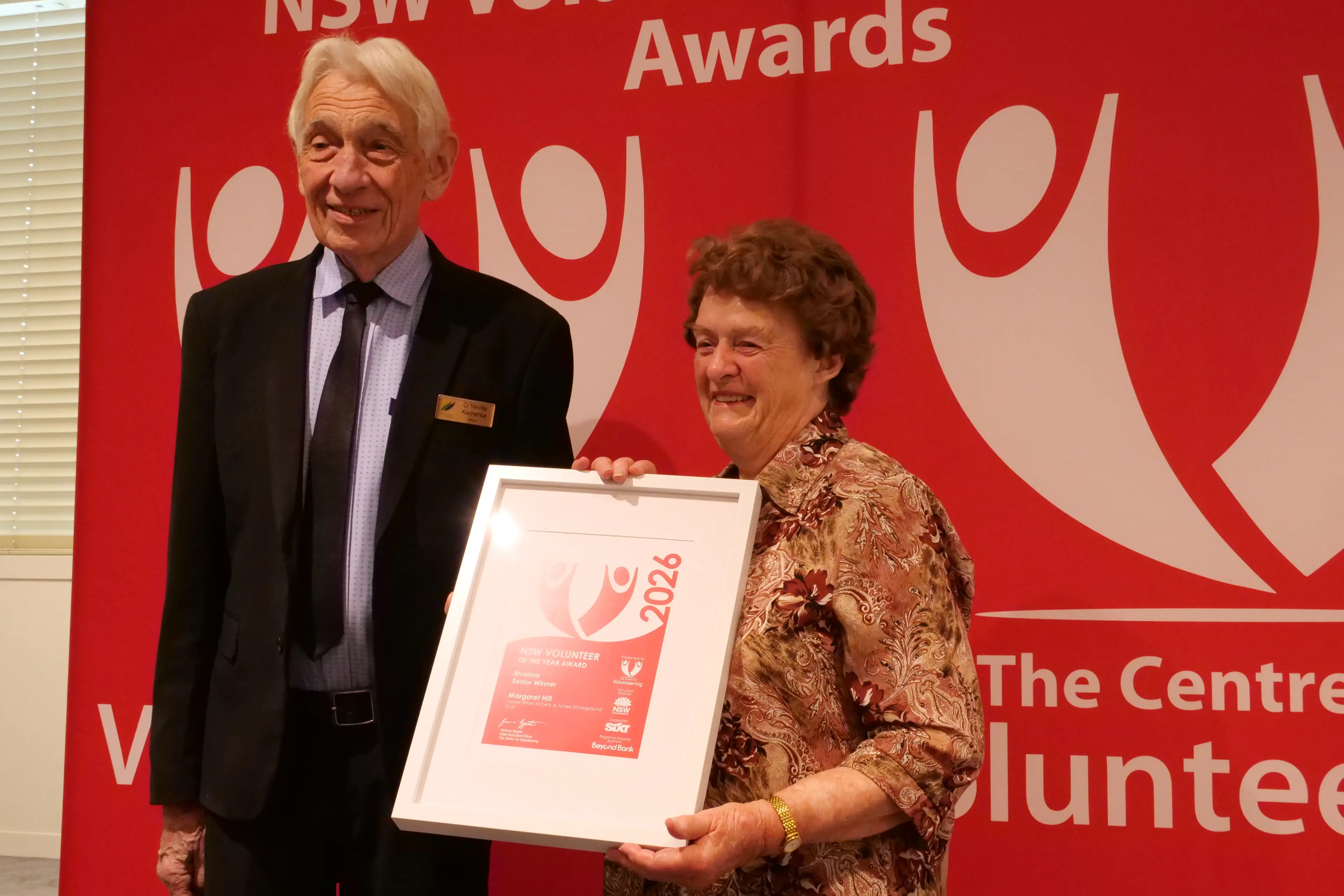 <p>Junee\\'s Margaret Hill recieved the Riverina 2026 Senior Volunteer of the Year from mayor of Narrandera Shire Council mayor Neville Kschenka</p>\\n