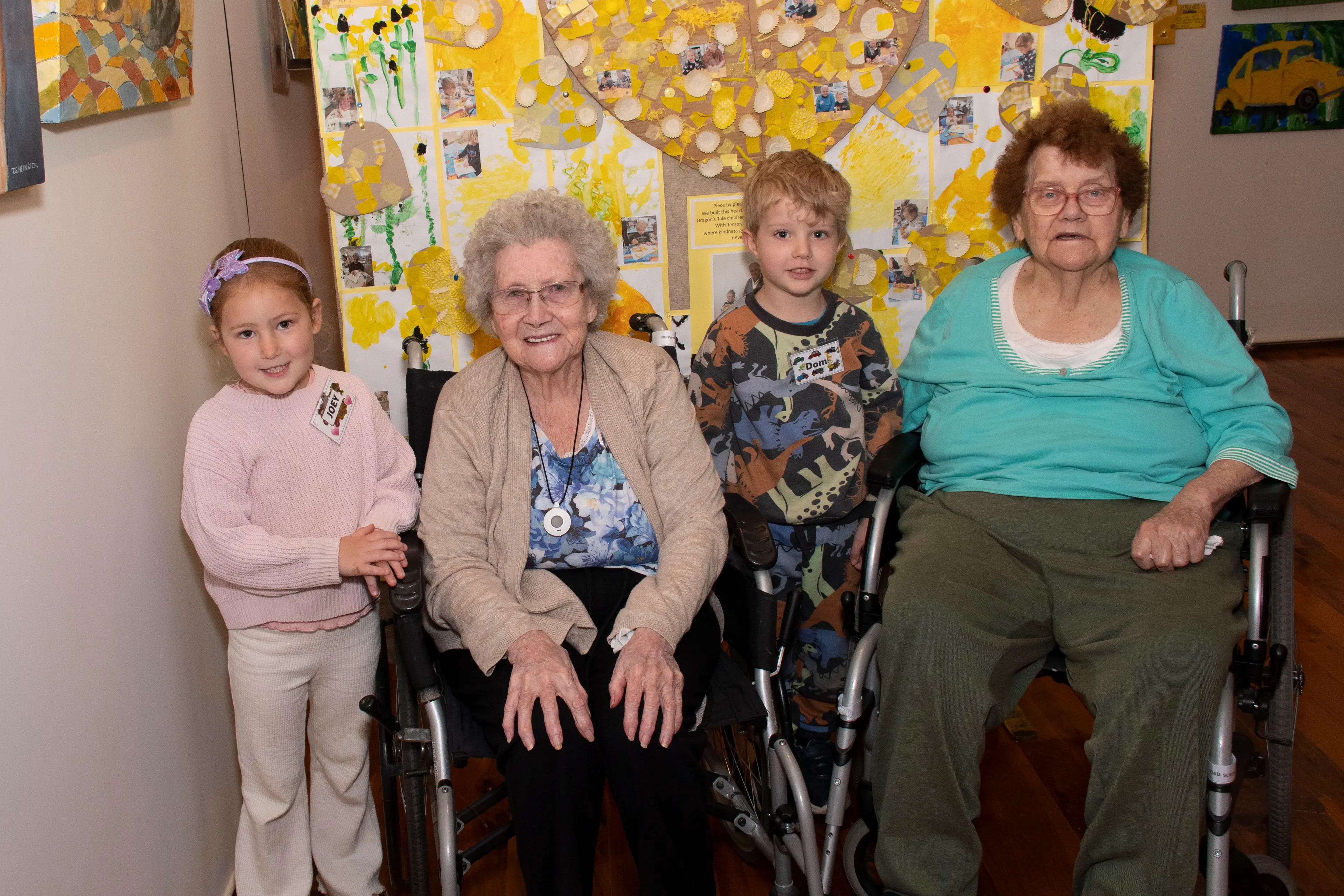 <p>Joey Overs, Silvia McMahon, Dom Johnson and Gloria Worth with some of the work created by the Intergenerational pre-school group at the Yellow Trail exhibition. PHOTO: Noel Fisher</p>\\n
