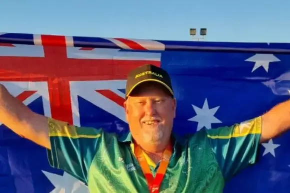 <p>Andrew Veigel proudly holding up the Australian flag. PHOTO: Supplied</p>\\n